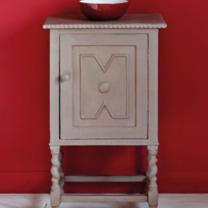 Side table painted with Chalk Paint® in Coco, a soft brown grey against a red wall of Emperor's Silk
