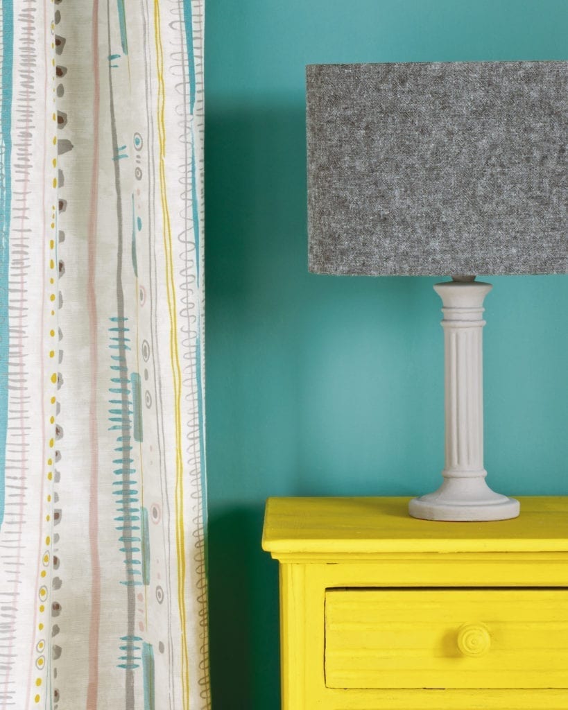 Side table painted with Chalk Paint® in English Yellow, a bright traditional yellow against a wall of Provence. Piano in Provence curtain and lampshade in Linen Union in Graphite + Old White