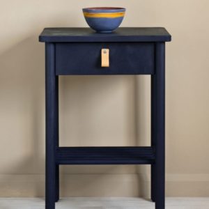 Side table painted with Chalk Paint® in Oxford Navy, an inky, traditional navy blue against a wall of Country Grey