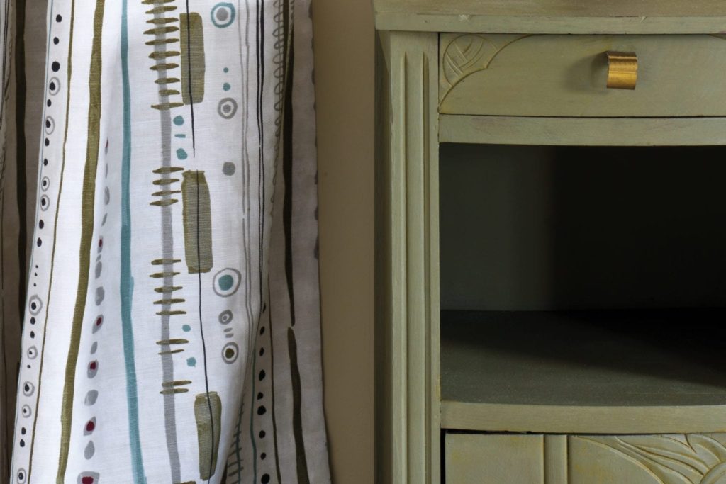 Side table painted with Chalk Paint® in Olive, a traditional olive khaki green. Piano in Olive curtain