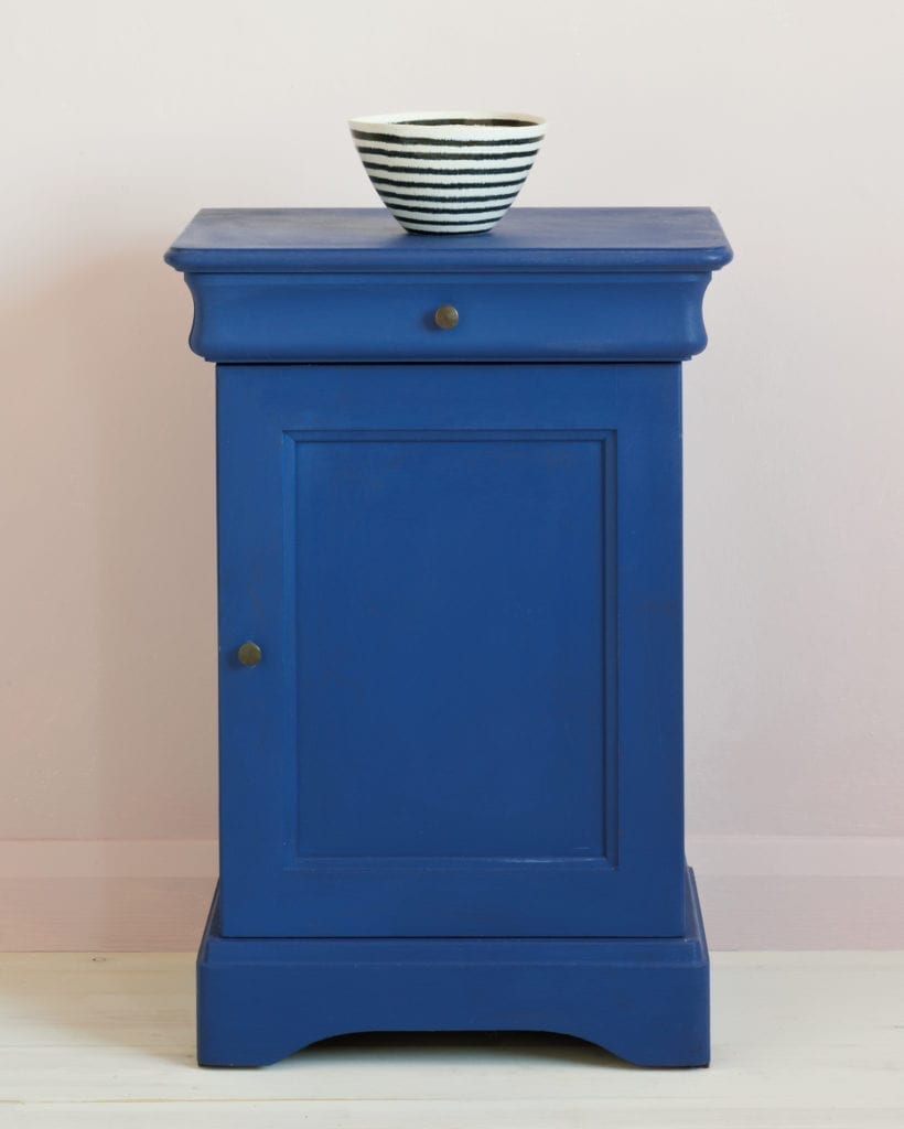 Side table painted with Chalk Paint® in Napoleonic Blue, a rich deep cobalt blue against a pink wall of Antoinette