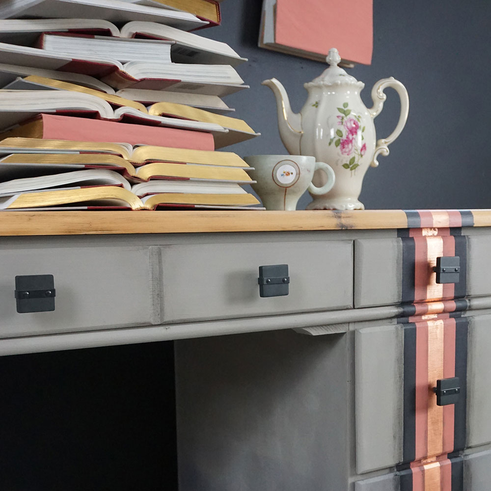 Close up of Scandinavian Pink Chalk Paint® desk, Olivia used a pile of books and teapot for staging