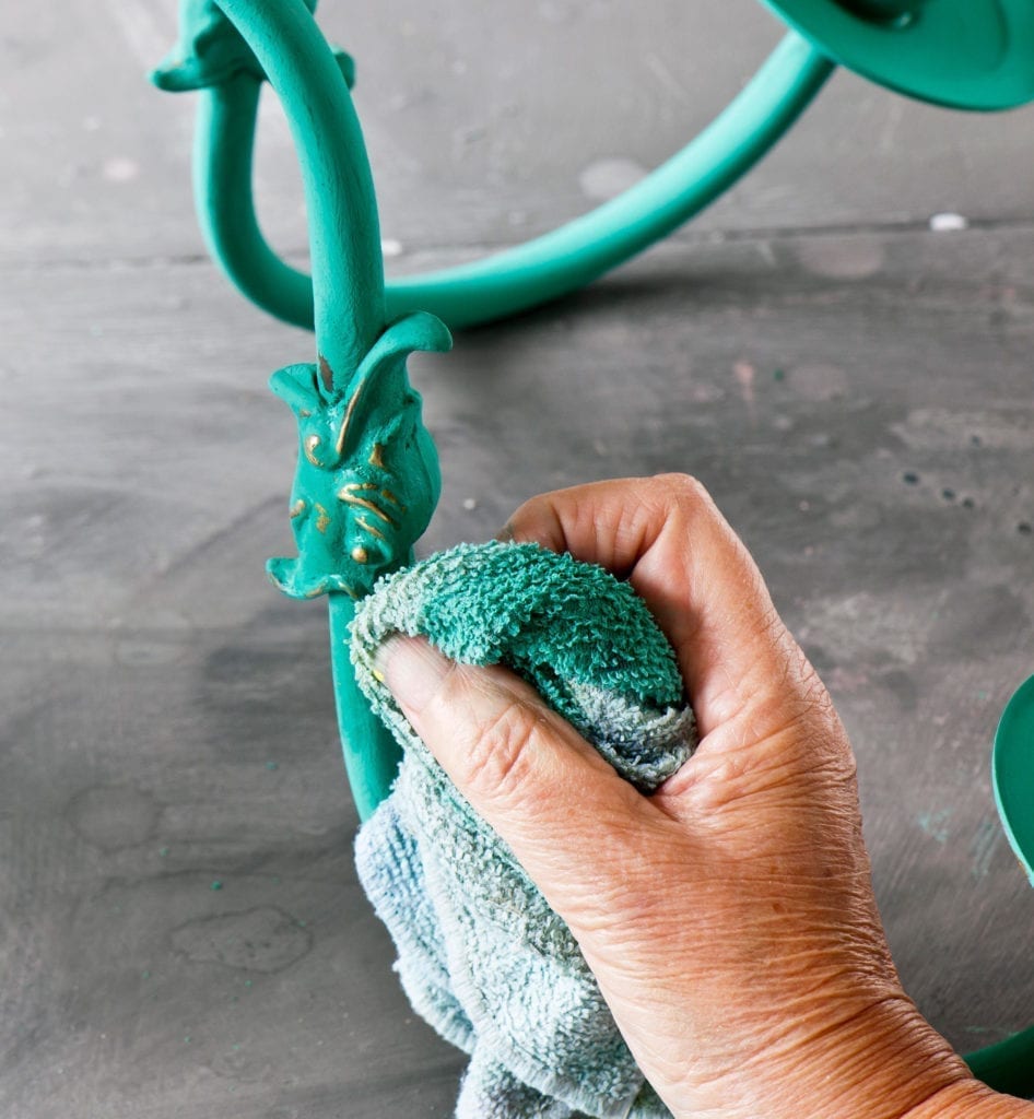 Annie painting a chandelier with Chalk Paint® in Florence. Taken from Annie Sloan Paints Everything published by Cico books photos by Christopher Drake