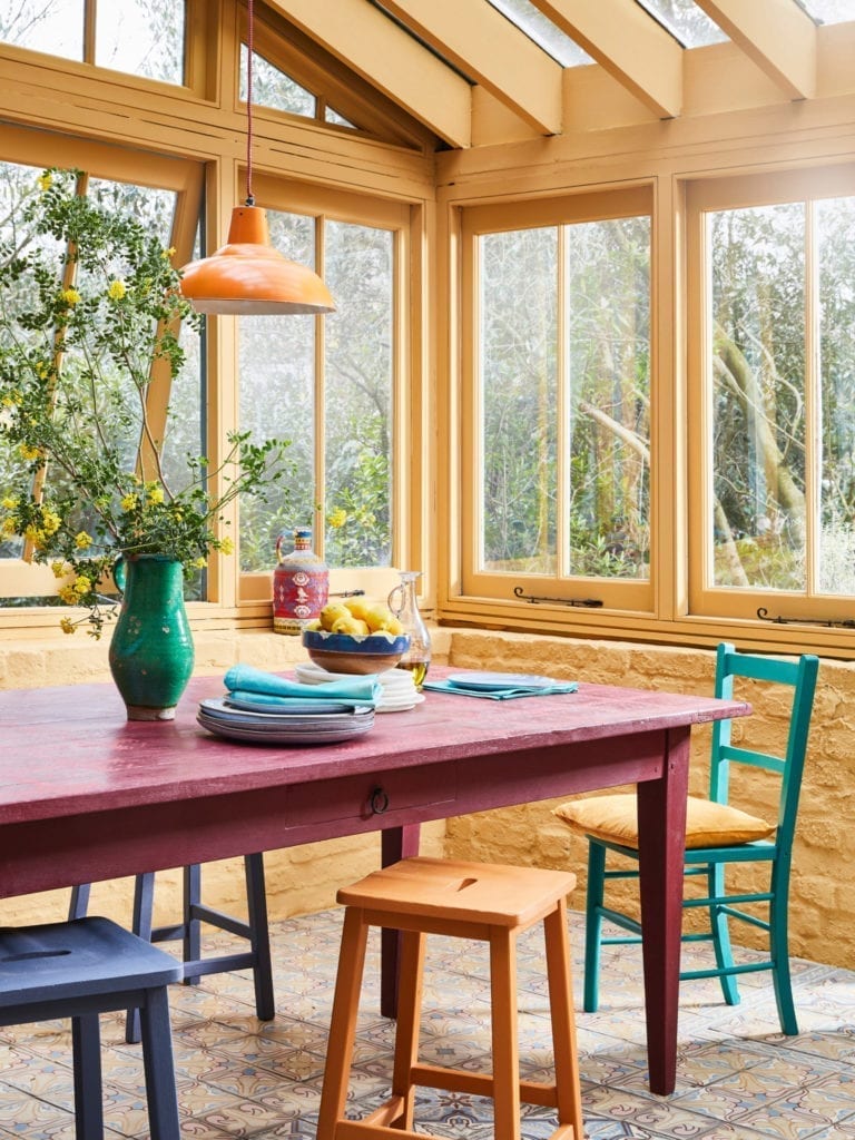 Sun room painted with Chalk Paint® by Annie Sloan in Arles. Chairs in Provence, Old Violet and Barcelona Orange and table in Burgundy