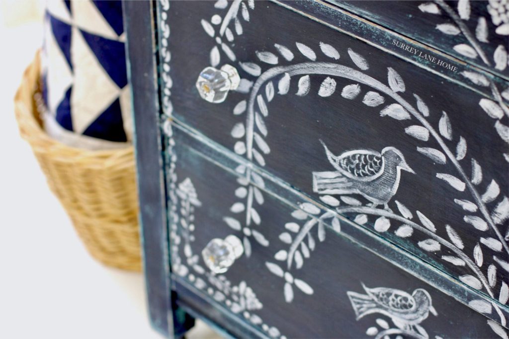 Cabinet painted with Chalk Paint® furniture paint by Annie Sloan in Oxford Navy by Surrey Lane Home, with a folk art design achieved with Detail Brushes