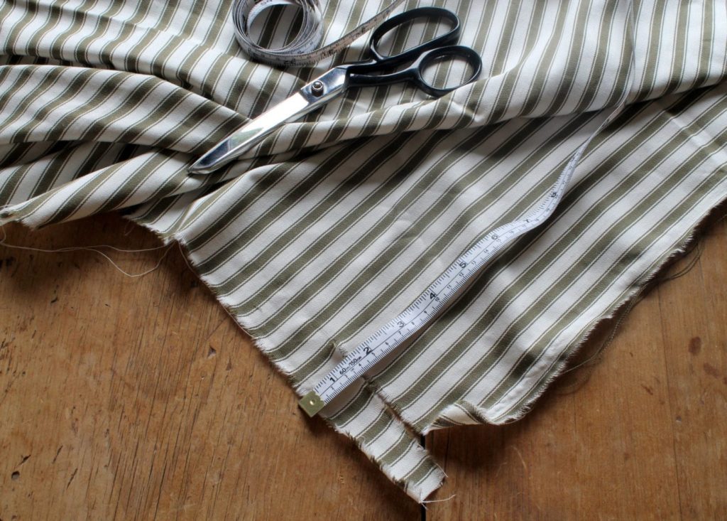 Ticking striped fabric by Annie Sloan in Olive being cut for an advent calendar