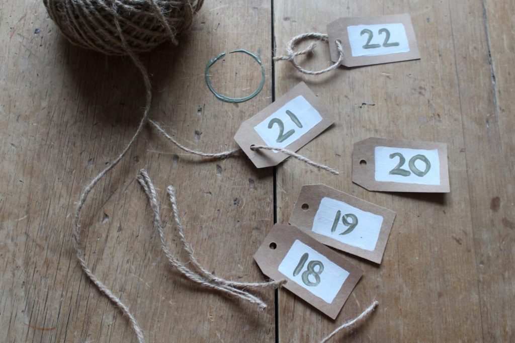 Parcel tags painted with Chalk Paint® by Annie Sloan in Old White and Olive for an advent calendar