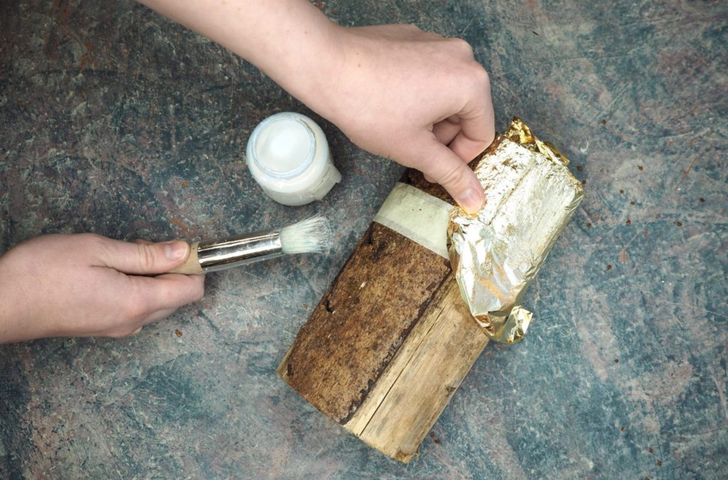 Wooden logs gilded with Gold Size and Loose Brass Leaf by Annie Sloan