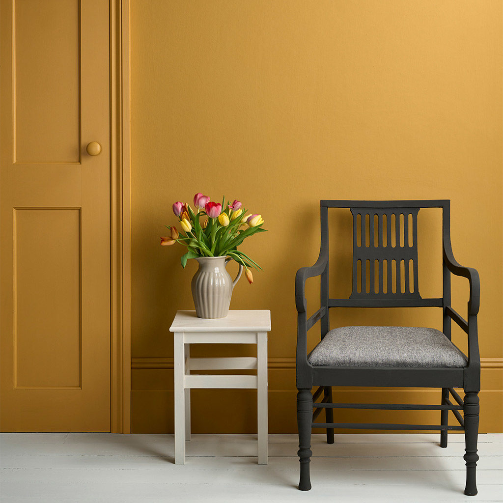 Annie Sloan Satin Paint in Carnaby Yellow Lifestyle Image featuring painted door, skirting, chair and accessories