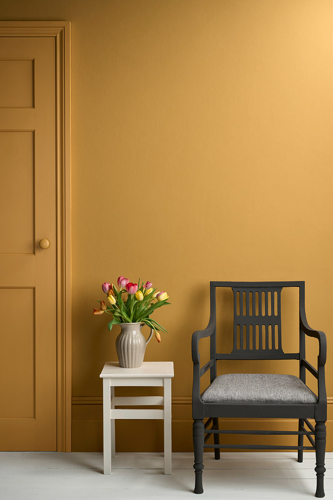 Lifestyle Image of Annie Sloan Satin Paint in Carnaby Yellow used on door and skirting