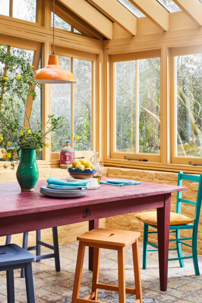 Annie Sloan Sunroom Painted in Arles, Burgundy, and Emperor's Silk Chalk Paint featuring Large Table and Chairs