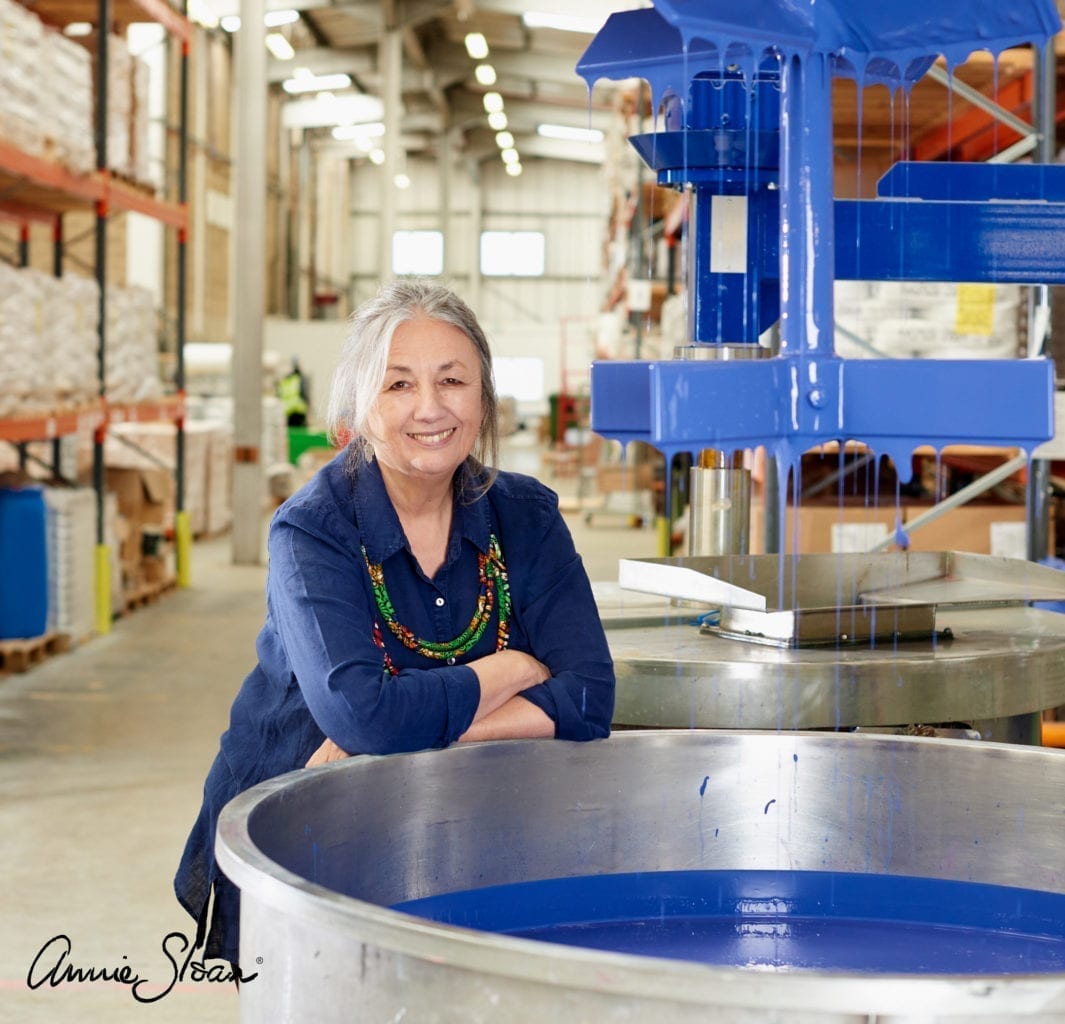 Annie Sloan by a Chalk Paint® in Napoleonic Blue paint vat in her Oxford warehouse