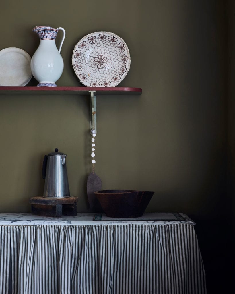 Kitchen painted with Chalk Paint in Olive and cabinet curtains in Ticking in Olive fabric by Annie Sloan