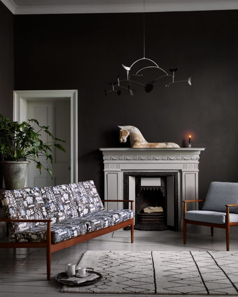 Wall Paint in Graphite living room, with Chalk Paint in Paris Grey fireplace and door. Mid-century modern sofas upholstered in Dulcet in Graphite fabric and Linen Union in Old Violet + Old White fabric by Annie Sloan