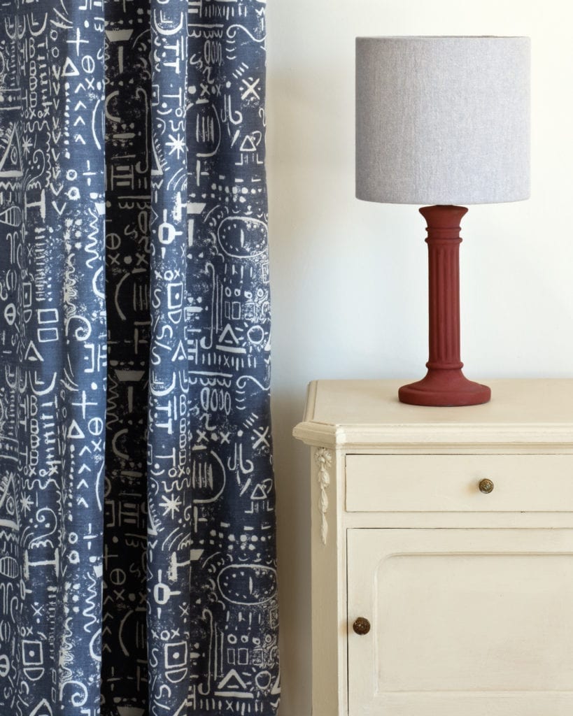 Side table painted with Chalk Paint® in Old Ochre, a soft warm neutral beige cream. Tacit in Old Violet curtain and Linen Union in Old White + French Linen lampshade