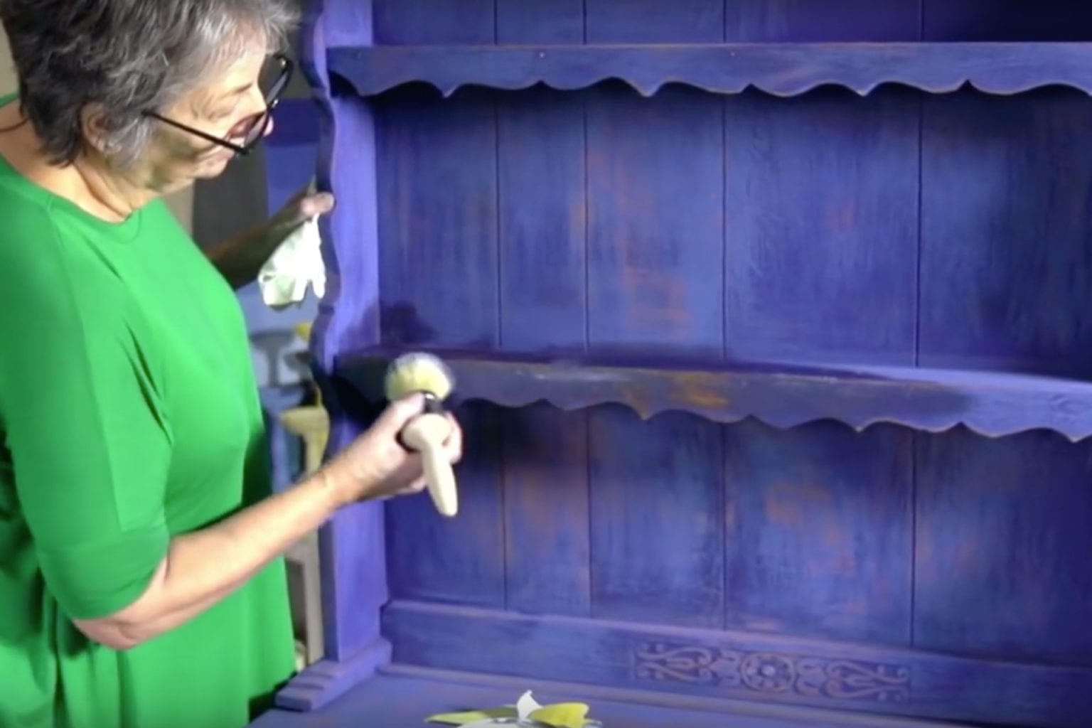 Annie Sloan waxing a rustic and distressed dresser