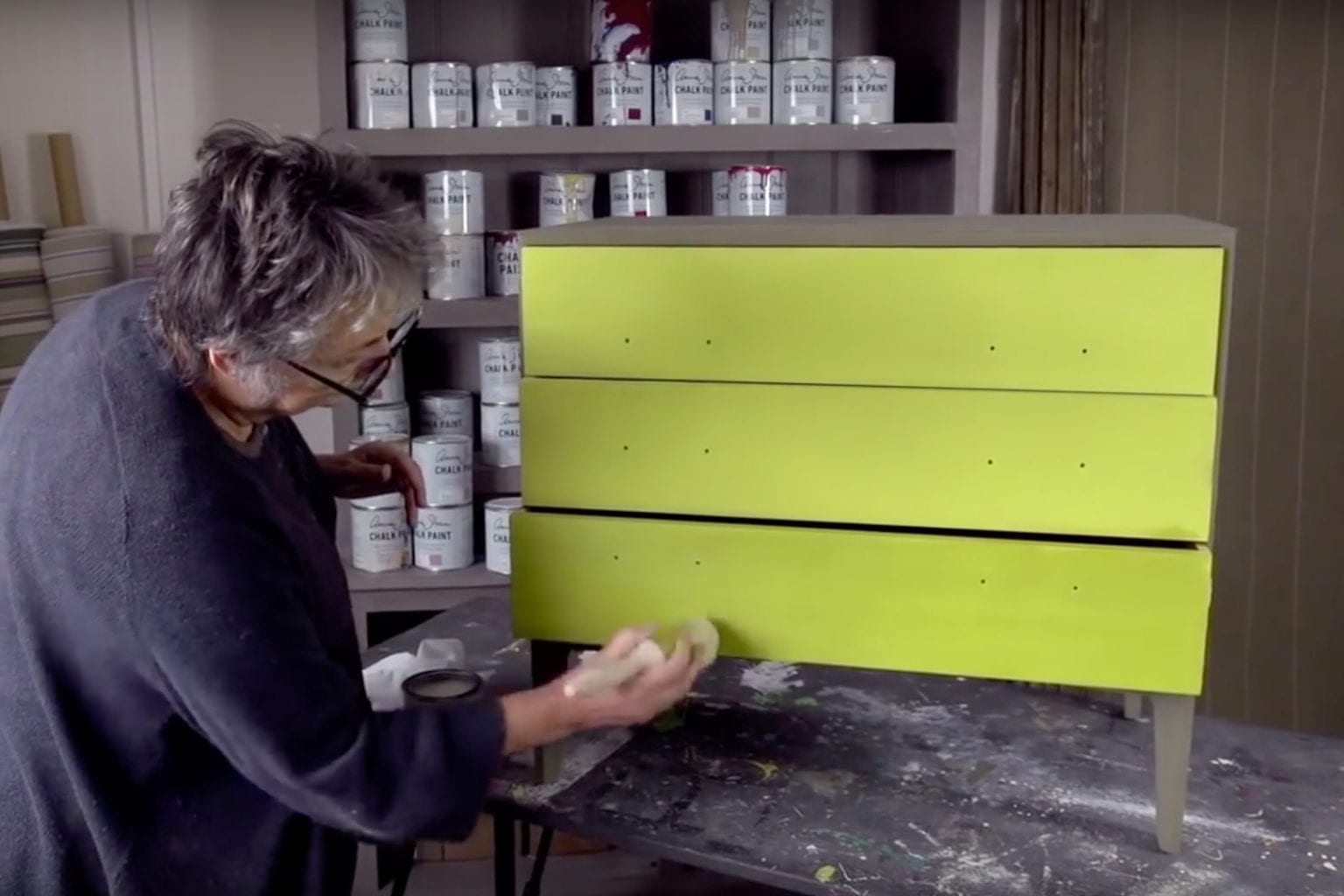 Annie Sloan waxing a smooth flat finish using Clear Chalk Paint® Wax on modern drawers painted with English Yellow and Antibes Green