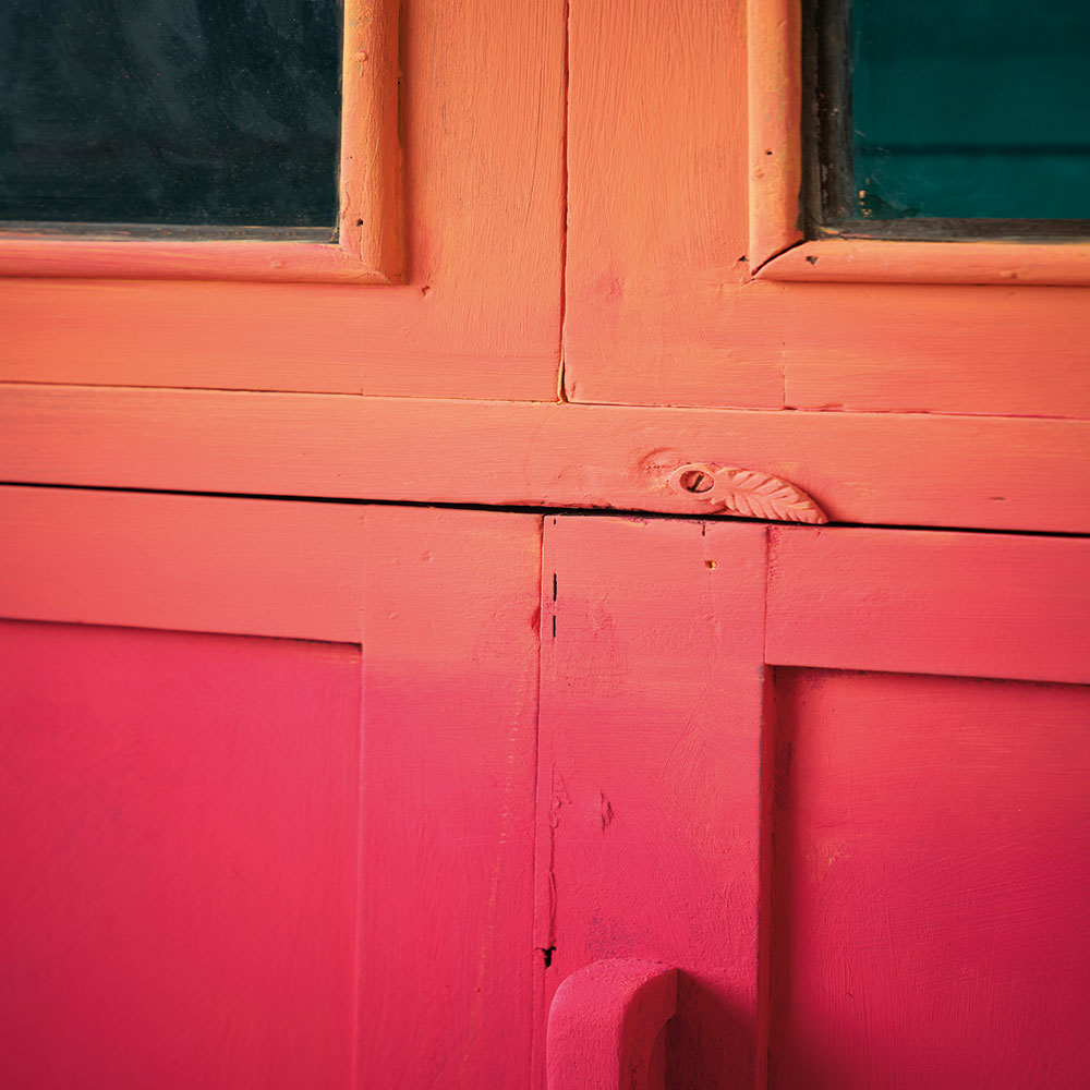 Close up of the Capri Pink and Barcelona Orange Chalk Paint® ombre cabinet