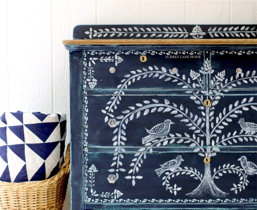 Cabinet painted with Chalk Paint® furniture paint by Annie Sloan in Oxford Navy by Surrey Lane Home, with a folk art design achieved with Detail Brushes