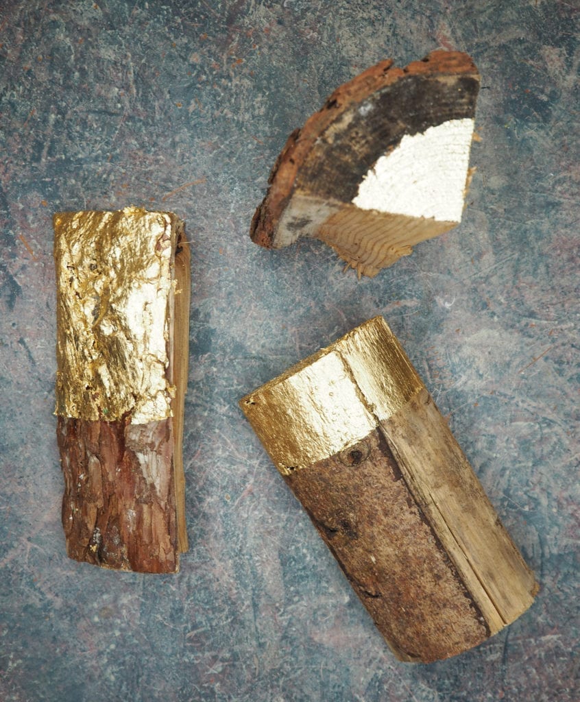 Wooden logs gilded with Gold Size and Loose Brass Leaf by Annie Sloan