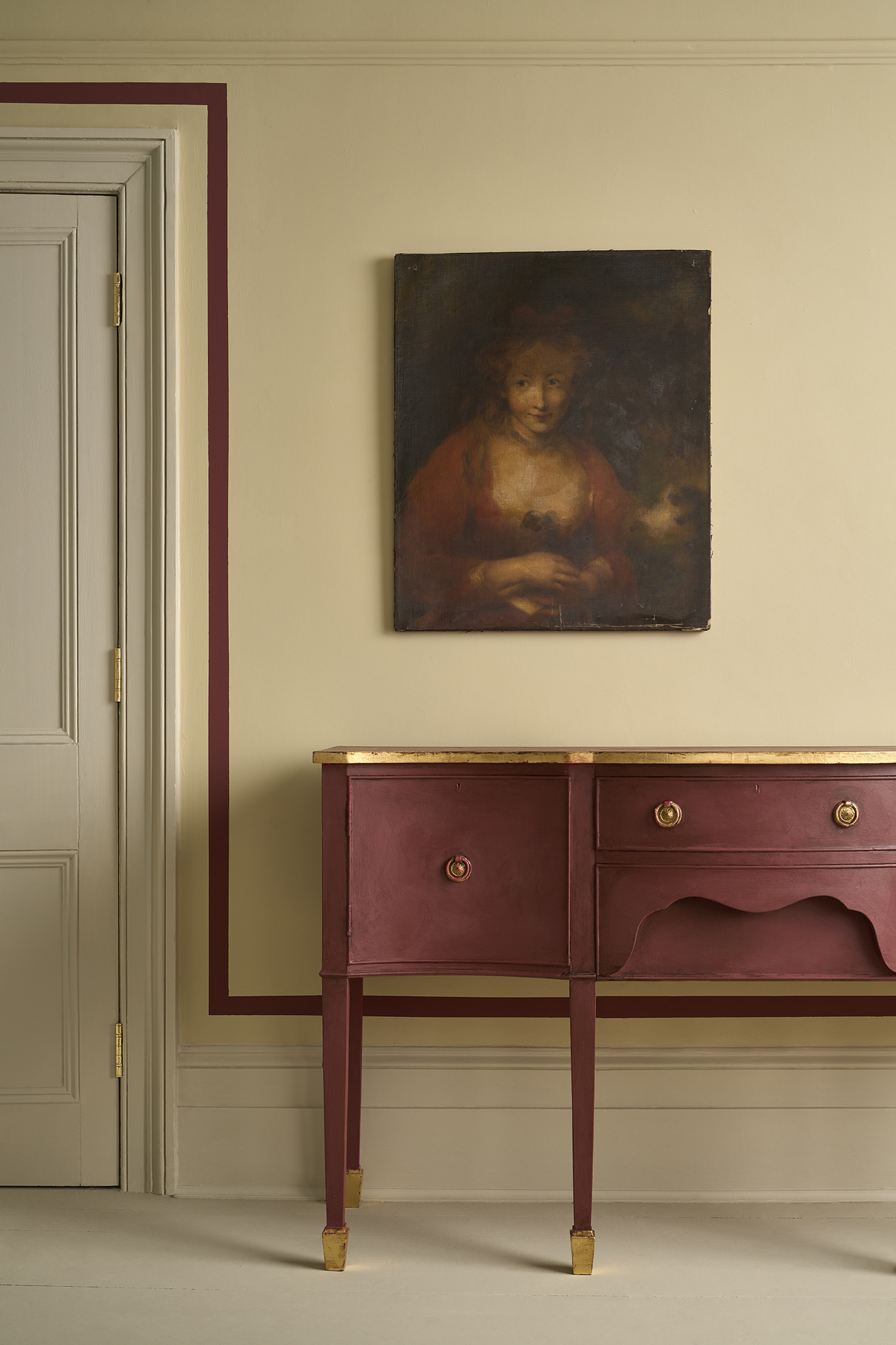 Old Ochre Wall Paint used behind a red chest of drawers, by Annie Sloan