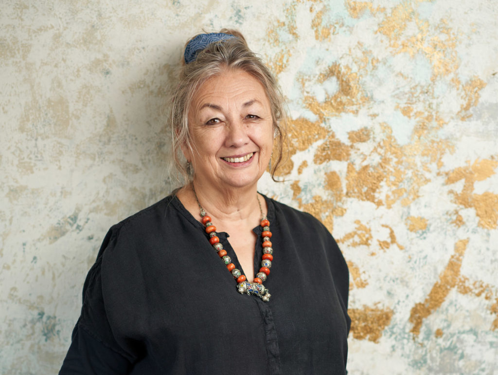 Portrait of Annie Sloan stood in front of a gold leaf wall