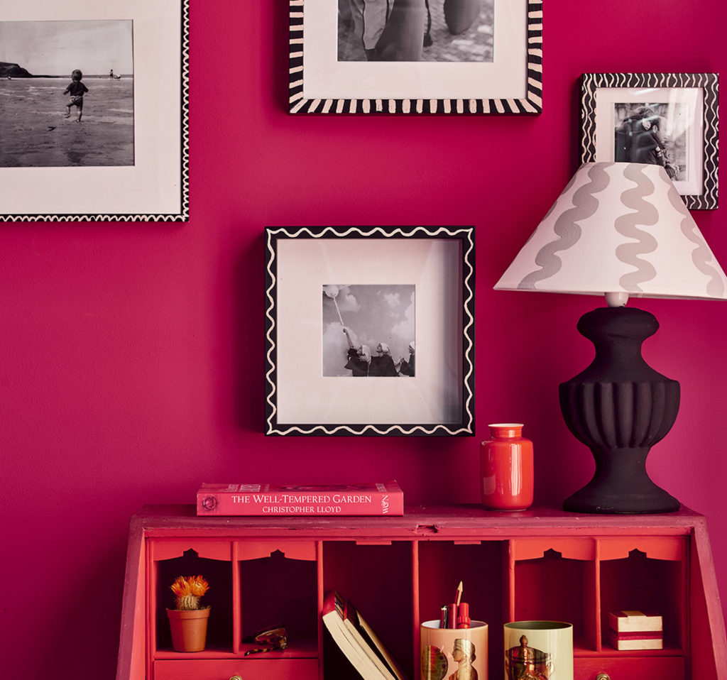 Close Up Chalk Painted Photo Frames and Lamp on Capri Pink Wall Paint Background