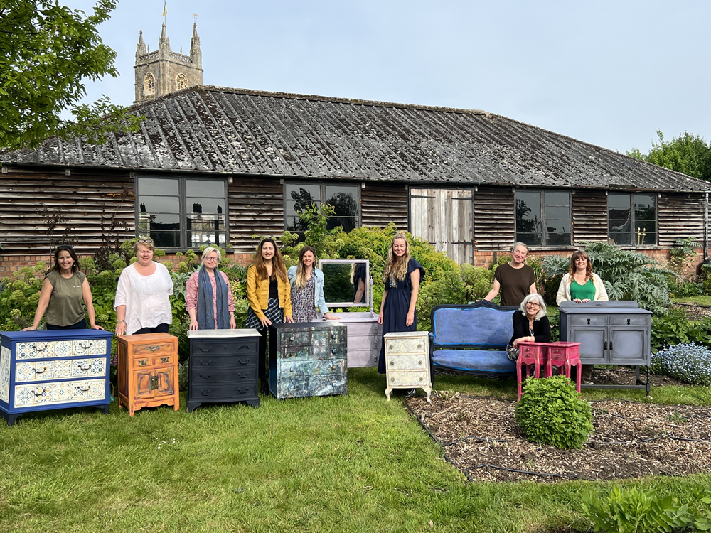 Guests and their painted pieces of furniture outside at Court House Farm
