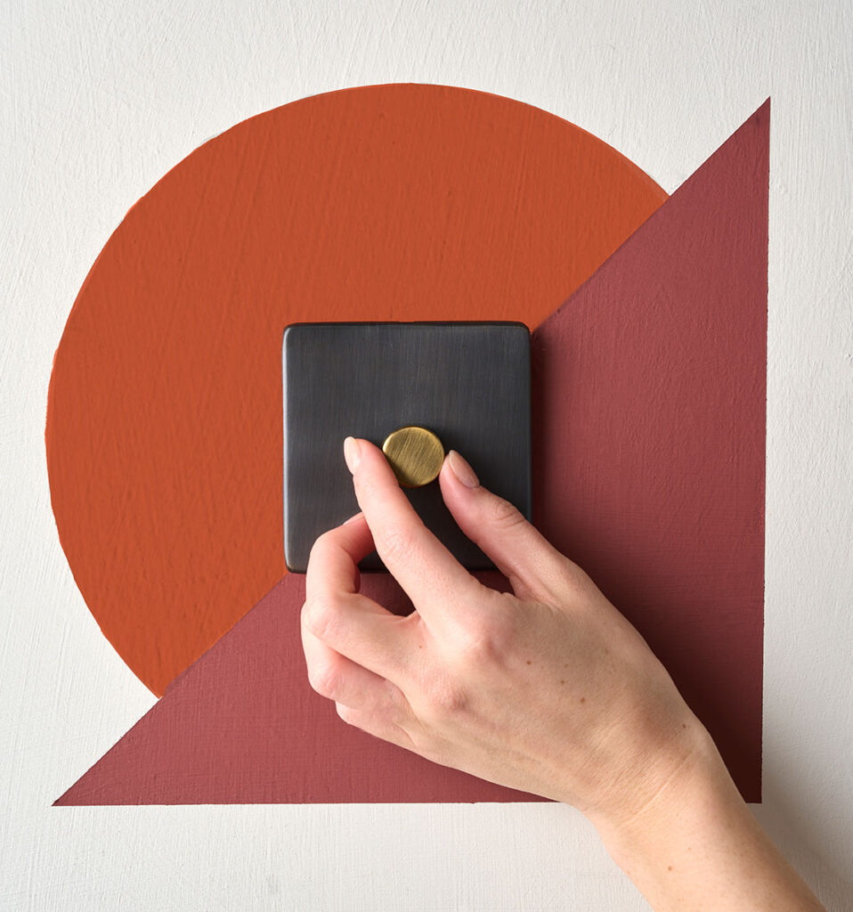 Annie Sloan Wall Paint used to create a geometric pattern around a Pooky light switch