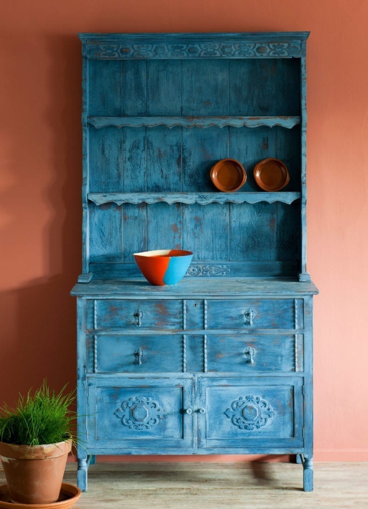 Distressed Kitchen Dresser painted with Chalk Paint® by Annie Sloan in Greek Blue, Napoleonic Blue and Primer Red. Wall in Scandinavian Pink.