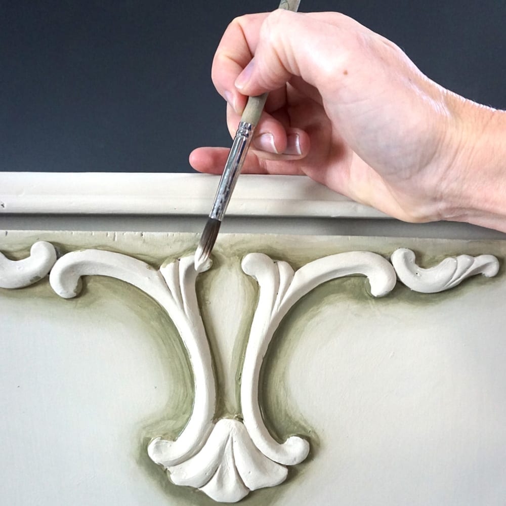 Olivia Lacy's demonstrating detailing on her Chalk Paint® cabinet