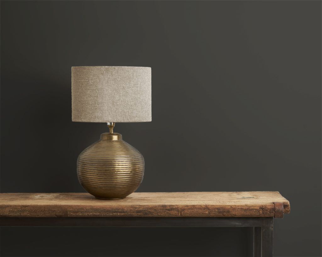 Annie Sloan's Graphite Wall Paint on a wall in front of a lamp