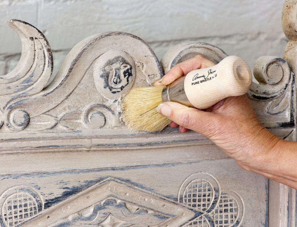 Annie Sloan using Clear Chalk Paint Wax on a rustic bench painted with Old Ochre