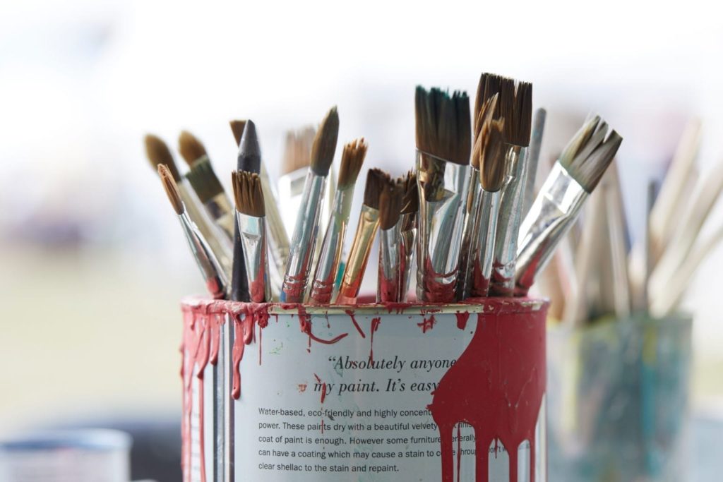 A retired Chalk Paint® tin being used to hold paint brushes