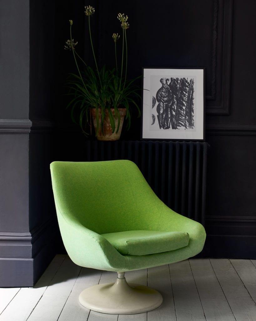 Modern retro mid-century armchair upholstered with Linen Union in English Yellow + Antibes Green fabric by Annie Sloan. Walls painted with Chalk Paint® in Oxford Navy