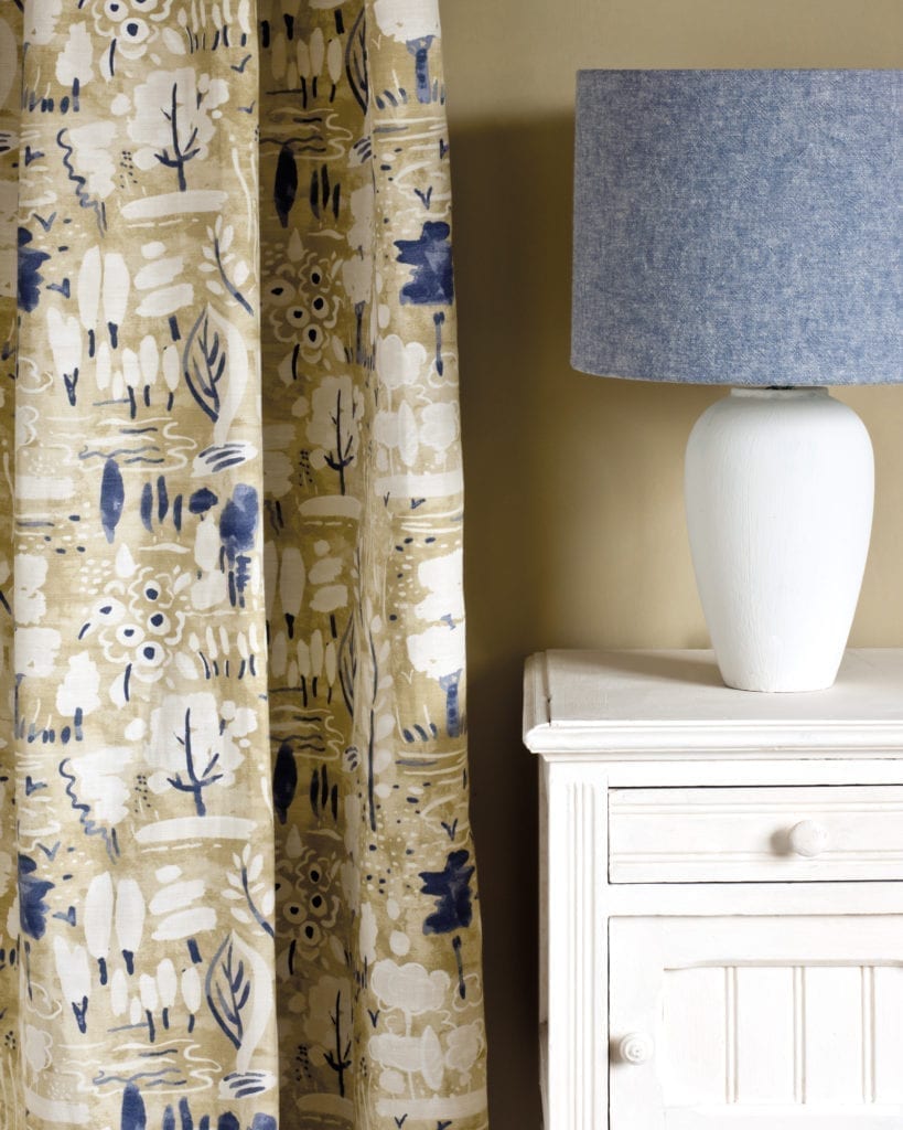 Side table painted with Chalk Paint® furniture paint by Annie Sloan in Original, a warm slightly creamy soft white. Curtain in Dulcet in Versailles and lampshade in Linen Union in Old Violet + Old White