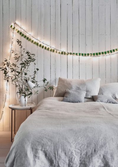 Neutral Scandinavian Bedroom painted with Chalk Paint® by Annie Sloan in Old White and fairy lights. Featuring Linen Union in Graphite + Old White