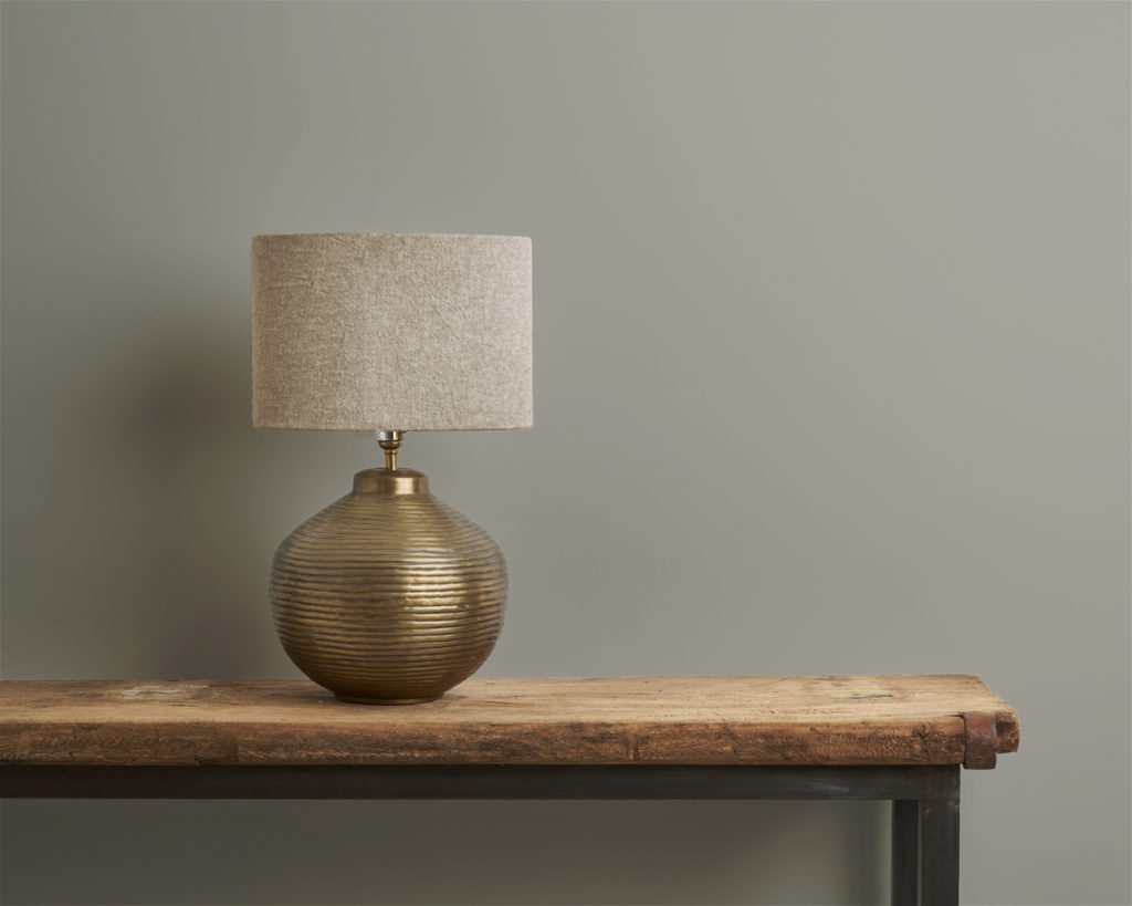 Paris Grey Wall Paint by Annie Sloan on a wall in front of lamp