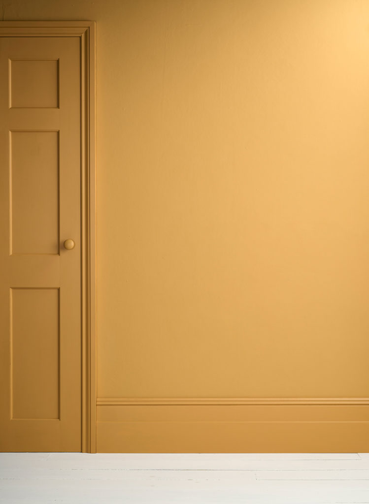 Lifestyle Image of Annie Sloan Satin Paint in Carnaby Yellow used on door and skirting