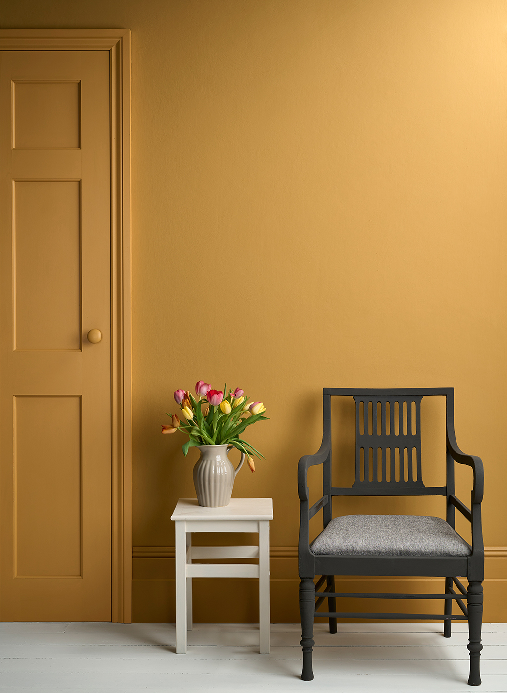 Lifestyle Image of Annie Sloan Satin Paint in Carnaby Yellow used on door and skirting