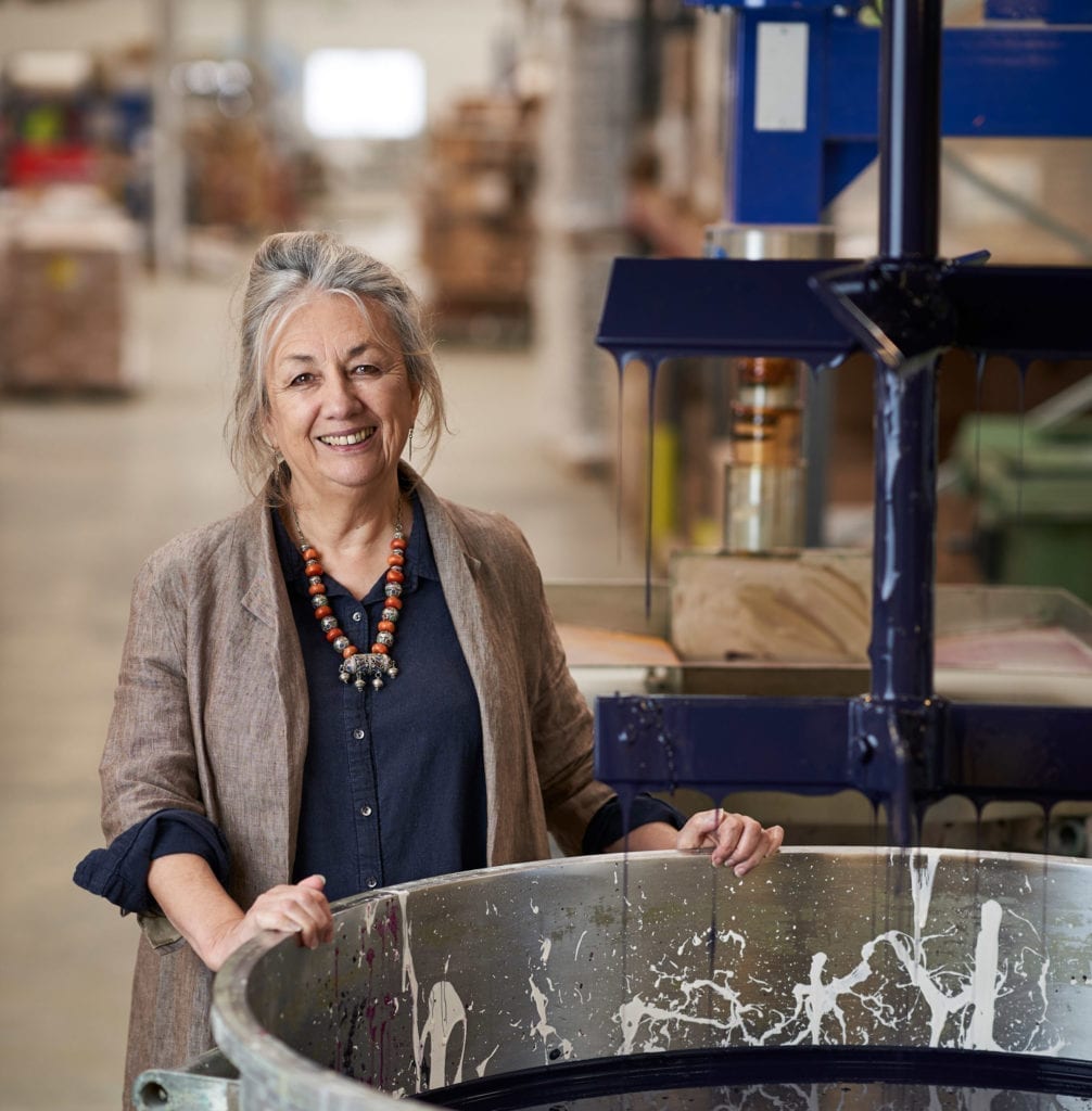 Annie Sloan in the factory in Oxford mixing Chalk Paint in Oxford Navy in a vat
