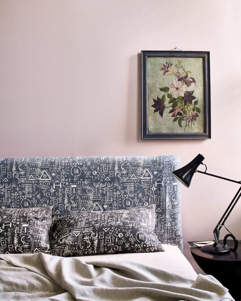 Bedhead and cushions made from Tacit in Graphite and Old Violet fabrics by Annie Sloan. Bedroom walls in Antoinette, a soft pale pink, Wall Paint.
