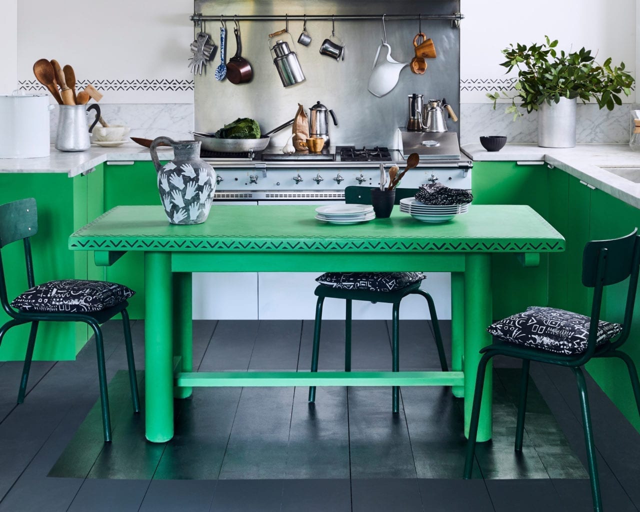 Kitchen table painted with Chalk Paint in Antibes Green and stencilled in Graphite with Valeska Stencil by Annie Sloan. Cushions in Tacit in Graphite fabric.