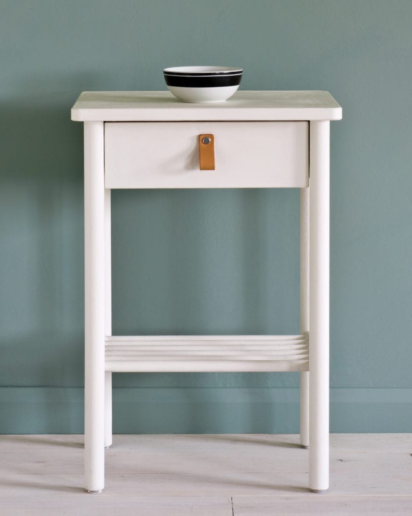 Side table painted with Chalk Paint® in Old White, a cool soft off-white, against a wall of Duck Egg Blue