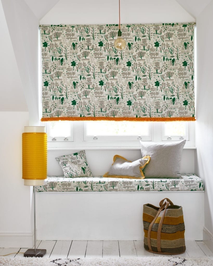 Window seat dressed with Dulcet in Old White fabric by Annie Sloan, using nature motifs in neutrals and green. Highlights of Orange finish the soft furnishings.