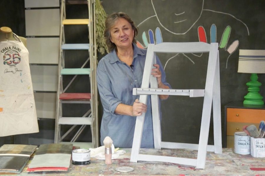 Annie Sloan painting a deck chair with Chalk Paint® furniture paint in Paris Grey and White Wax for a coastal look