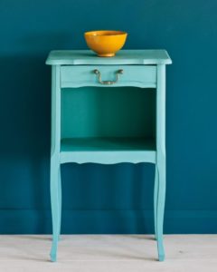 Side table painted with Chalk Paint® in Provence, a light blue-green turquoise against a wall of Aubusson Blue