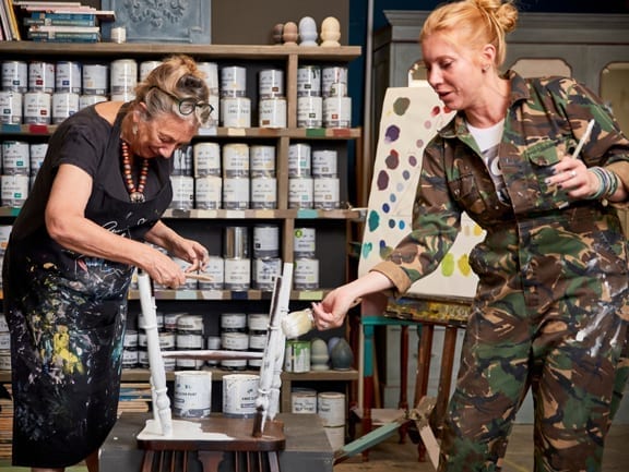 Annie Sloan and Lynne Lambourne painting a chair with Chalk Paint® in Old White