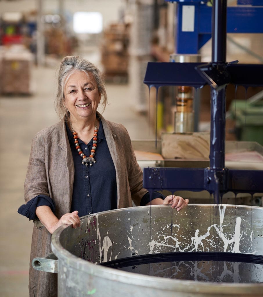 Annie Sloan in the factory in Oxford mixing Chalk Paint in Oxford Navy in a vat