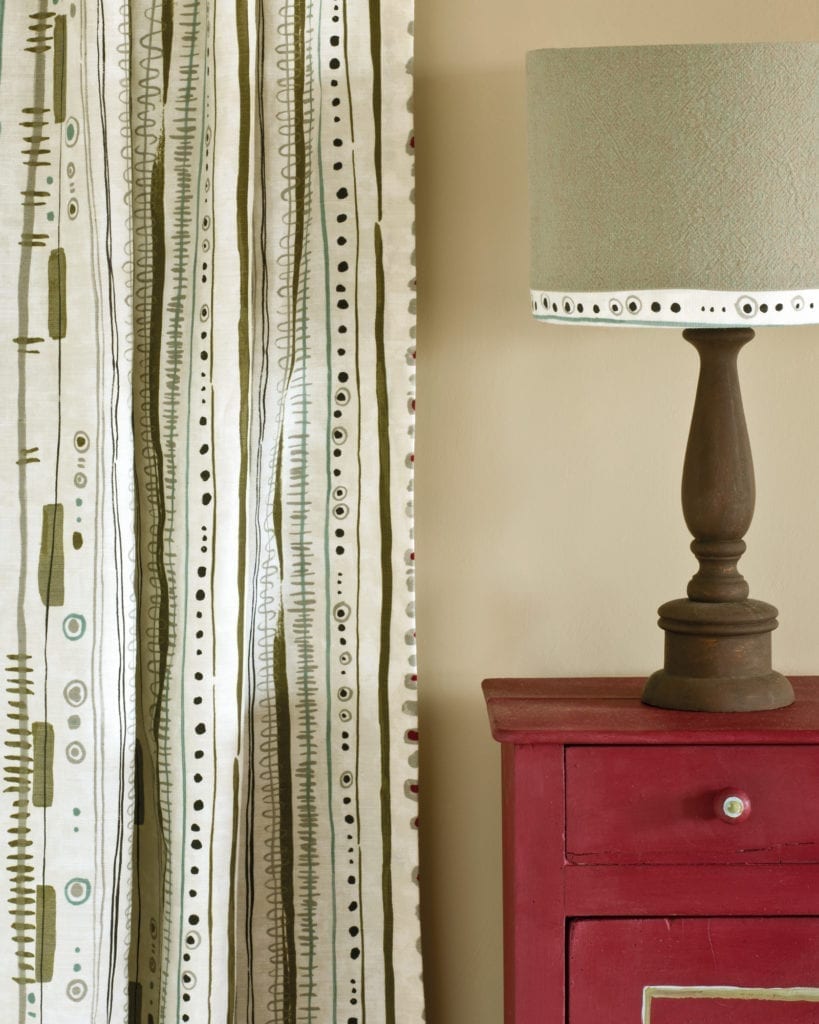 Side table painted with Chalk Paint® in Burgundy, a rich deep warm red. Curtain in Piano in Olive and lampshade in Linen Union in Coco + Duck Egg Blue